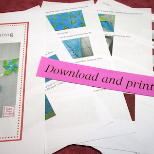 May include: A collection of printed instructions and a sample image for making pinwheel bunting. The sample image shows a garland of colorful pinwheels in red, blue, and green. The text "Download and print at home" is visible on a pink strip.