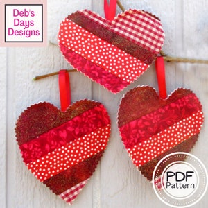 May include: Three red fabric hearts with different patterns, including red and white polka dots, red gingham, and red floral print. The hearts are hanging from a branch with red ribbon. The text "PDF Pattern" is visible in the lower right corner of the image.