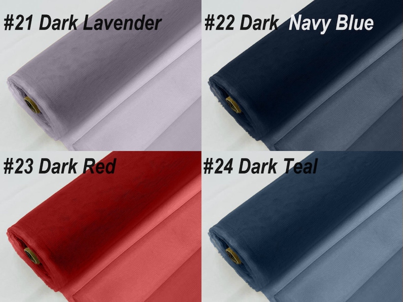 May include: Four rolls of fabric in different colours: dark lavender, dark navy blue, dark red, and dark teal. Each roll is labelled with a number and colour name.