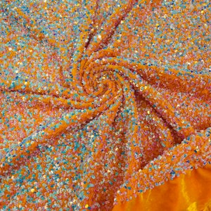 May include: Orange fabric with iridescent sequins. The sequins are scattered randomly across the fabric, creating a shimmering effect.