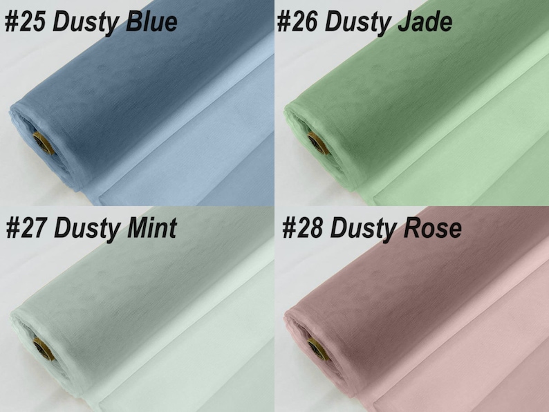 May include: Four rolls of tulle fabric in different colours: dusty blue, dusty jade, dusty mint, and dusty rose. The fabric is rolled up and the ends are visible.