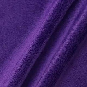 May include: A close-up of a soft, plush fabric in a deep purple hue. The fabric has a subtle texture and a slightly fuzzy appearance.