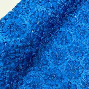 May include: Royal blue fabric with a 3D floral design and sequins.
