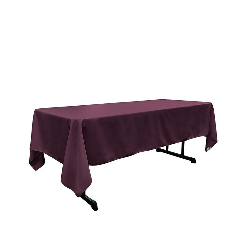 May include: A deep purple rectangular tablecloth draped over a table. The tablecloth is made of a smooth, wrinkle-resistant fabric.