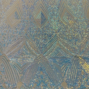 May include: A light blue iridescent sequin fabric with a geometric pattern. The fabric has a mesh backing.