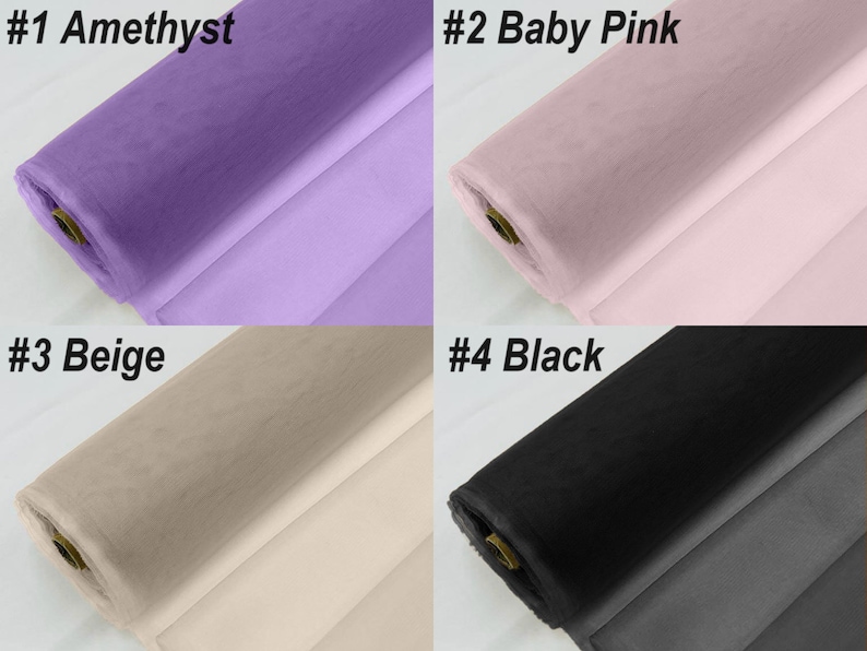 May include: Four rolls of tulle fabric in different colours: amethyst, baby pink, beige, and black. The fabric is rolled up and the ends are visible.
