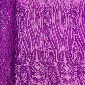 May include: Purple fabric with a paisley pattern and silver glitter. The fabric is sheer and has a delicate texture.