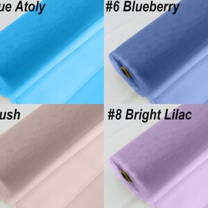 May include: Four rolls of tulle fabric in different colours: blue, light blue, blush pink, and lilac. The fabric is rolled up and the ends are visible. The numbers #5, #6, #7, and #8 are visible in the top corners of each roll, along with the colour names: Blue Atoly, Blueberry, Blush, and Bright Lilac.