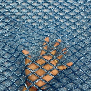 May include: Blue sequined fabric with a diamond pattern. The fabric is sheer and has a delicate, sparkly look.