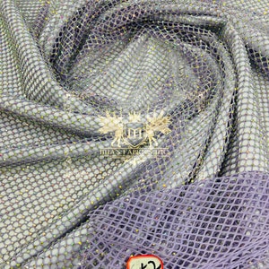 May include: Purple mesh fabric with iridescent sequins. The fabric has a diamond-shaped pattern. A red tag with the number 52 is attached to the fabric.