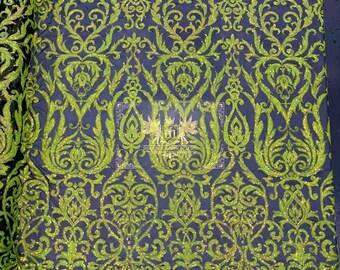 May include: Green glitter fabric with a damask pattern on a black mesh background.