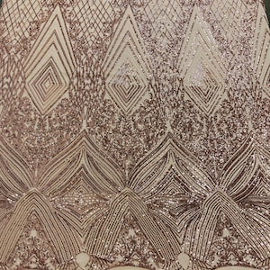 May include: Rose gold sequined fabric with a geometric pattern. The fabric has a mesh backing.