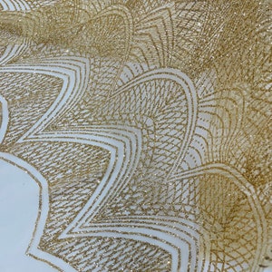 May include: Gold glitter fabric with a geometric pattern. The fabric has a sheer, mesh-like texture.