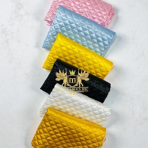 May include: A white ceramic mug with a black handle and the text "But First, Coffee" in a black, bold font. The mug is on a white surface. The mug is likely for hot beverages.