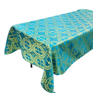 May include: A turquoise tablecloth with a gold cross pattern. The tablecloth is made of a soft, luxurious fabric and is perfect for any special occasion.