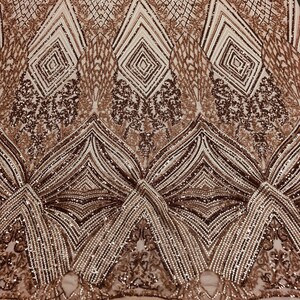 May include: Rose gold sequined fabric with a geometric pattern. The fabric has a sheer mesh backing.