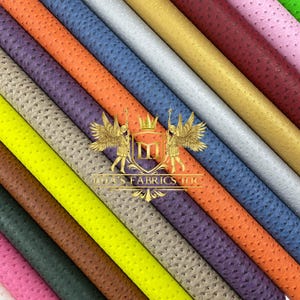 May include: A collection of rolled faux leather fabrics in various colors, including pink, green, and gold. The fabrics have a textured, dotted pattern. The image includes the text "Lila's Fabrics LLC".