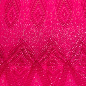 May include: Pink sequined fabric with a geometric pattern. The sequins are arranged in a diamond shape and create a shimmering effect.