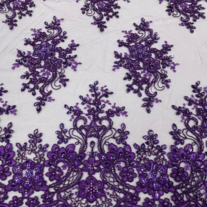 May include: Purple beaded lace fabric with a floral design. The lace has a scalloped edge and is embellished with sequins.