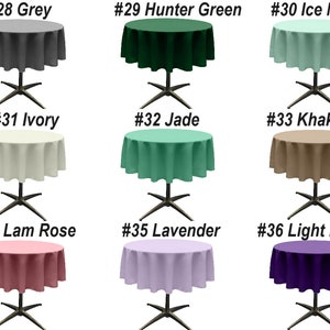 May include: Nine round tablecloths in various colors, including grey, hunter green, ice mint, ivory, jade, khaki, lam rose, lavender, and light purple. Each tablecloth is draped over a round table with a black, X-shaped base.