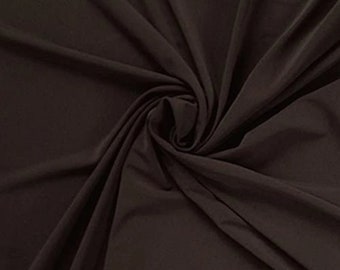 May include: A close-up of a smooth, dark brown fabric. The fabric is draped and folded, showing its texture and drape.