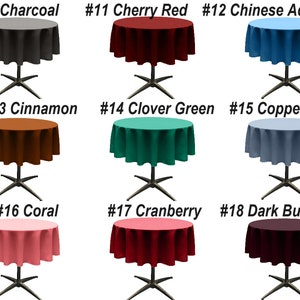 May include: Nine round tablecloths in various colors, including charcoal, cherry red, Chinese aqua, cinnamon, clover green, coppen blue, coral, cranberry, and dark burgundy. Each tablecloth is draped over a round table with a black metal base.