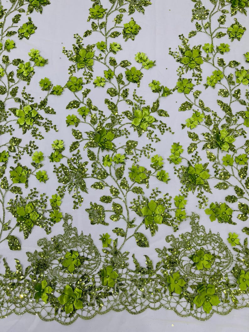 May include: Green floral lace fabric with 3D flowers and glitter. The fabric has a delicate, intricate design and is perfect for adding a touch of elegance to any project.