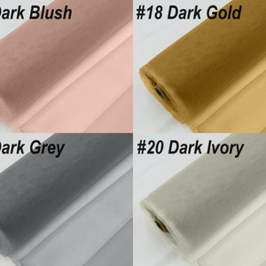May include: Four rolls of tulle fabric in different colours: dark blush, dark gold, dark grey, and dark ivory. The fabric is rolled up and the ends are visible.