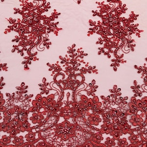May include: Burgundy beaded lace fabric with a floral pattern. The lace has a scalloped edge and is embellished with small beads.