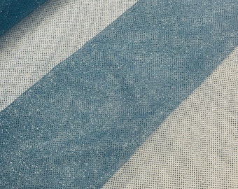 May include: A roll of light blue glitter tulle fabric. The fabric has a fine mesh texture and is perfect for crafting and decorating.
