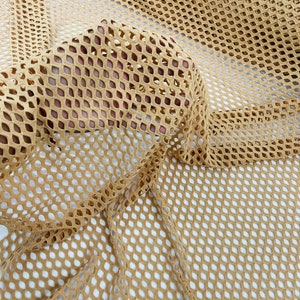 May include: A close-up of a beige mesh fabric with a diamond pattern. The fabric is soft and flexible, and it has a slightly textured surface.