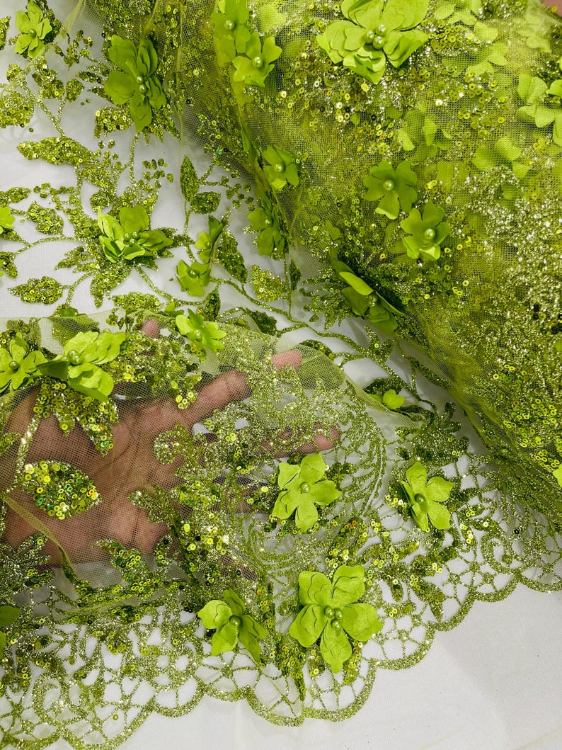 May include: Green floral lace fabric with sequins and 3D flowers. The fabric has a mesh base and is embellished with green sequins and 3D flowers.
