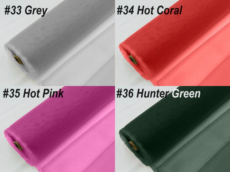 May include: Four rolls of tulle fabric in different colours: grey, hot coral, hot pink, and hunter green. The fabric is rolled up and the ends are visible.