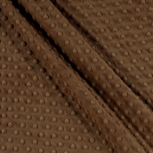 May include: Brown minky fabric with a textured dot pattern. The fabric is soft and plush.
