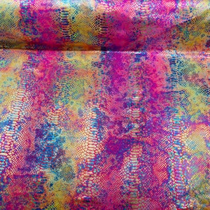 May include: A close-up of iridescent fabric with a snakeskin pattern in shades of pink, blue, yellow, and gold.