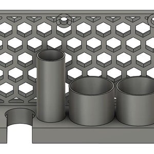 May include: A gray wall-mounted organizer with a honeycomb pattern. It has three round holes and a rectangular opening for holding items. There are two gray cylindrical containers and a gray rectangular container.