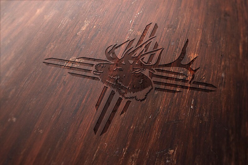May include: A detailed wood carving of an elk head with large antlers, set against a stylized cross design. The carving is set on a dark brown, textured wooden surface, showcasing the natural wood grain.