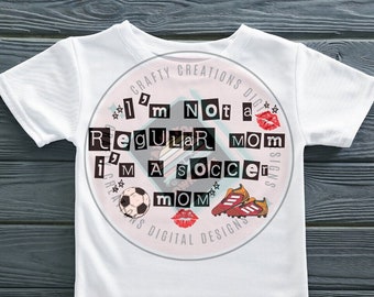 May include: White t-shirt with a pink circle design that says "I'm not a regular mom, I'm a soccer mom" with a soccer ball, soccer cleats, and lips.