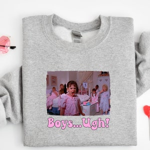 May include: Gray sweatshirt with a graphic print of a girl with a disgusted expression saying "Boys... Ugh!" The girl is surrounded by other girls in a bedroom setting.