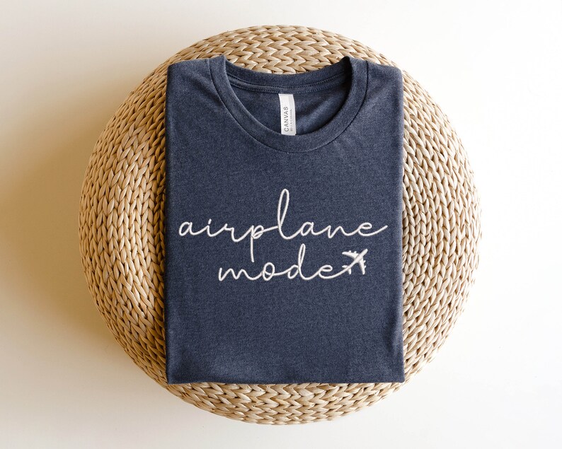 May include: A dark grey t-shirt with the text "airplane mode" in white lettering and a small airplane icon.
