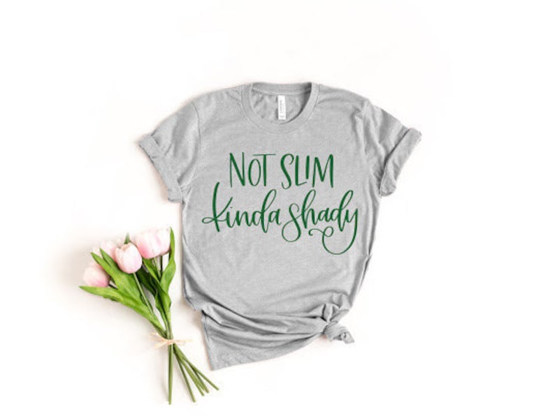 May include: Gray t-shirt with the text "Not Slim Kinda Shady" in green lettering.