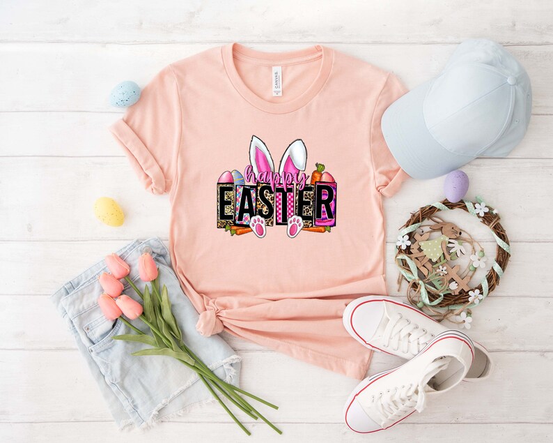 May include: A pink t-shirt with a graphic of bunny ears and the text "Happy Easter" in a colorful, patterned box.