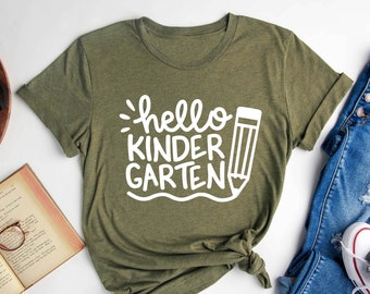 May include: A green t-shirt with the text "hello kindergarten" and a pencil graphic in white.