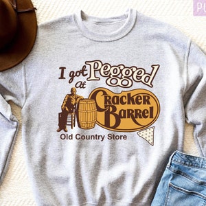 a sweater with a cowboy hat on top of it