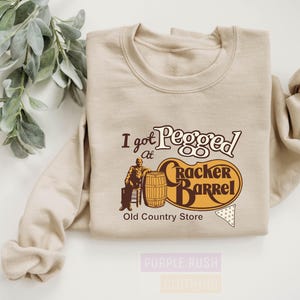 a t - shirt with a picture of an old country store on it