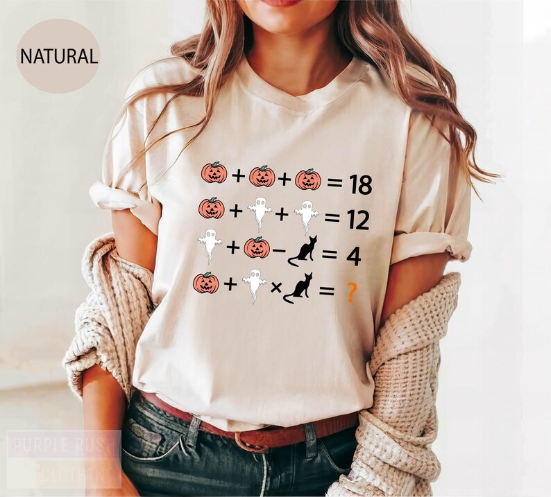 a woman wearing a white t - shirt with a halloween graphic on it