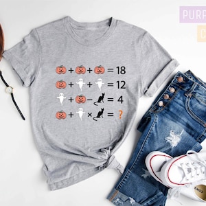 a t - shirt with pumpkins on it and a pair of jeans