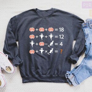 a sweatshirt that has a picture of a person on it and a pair of jeans