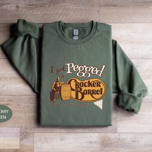 a green shirt with a picture of a man on it