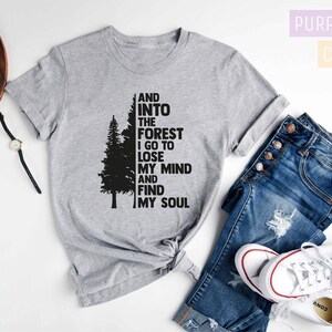 May include: Gray t-shirt with a black silhouette of a tree and the text "AND INTO THE FOREST I GO TO LOSE MY MIND AND FIND MY SOUL".
